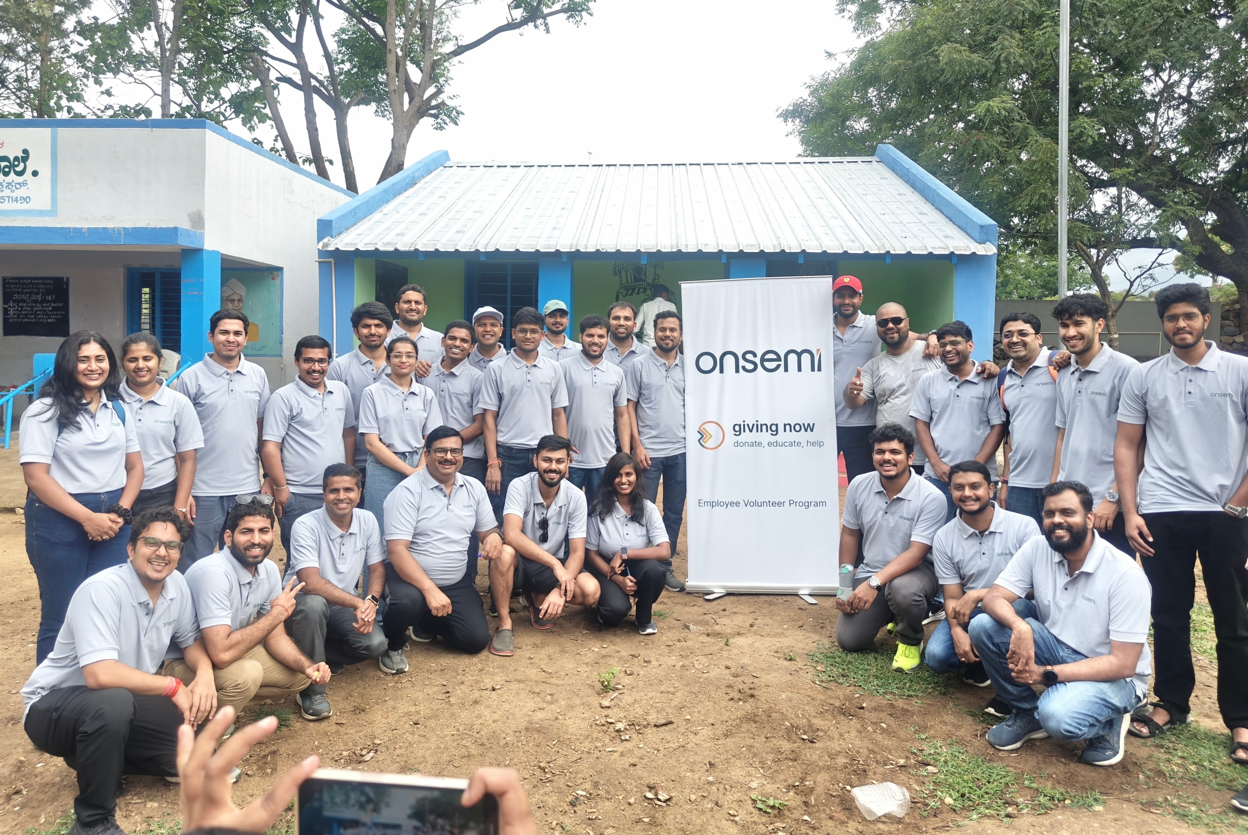 onsemi employees standing by a pile of food they collected to help others.